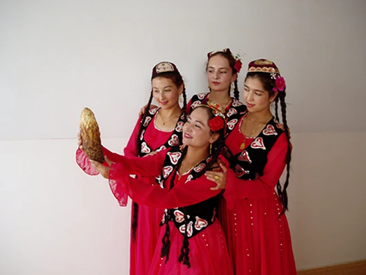 Uyghur girl holding Cistanche deserticola in her hand Uyghur girl holding Cistanche deserticola in her hand